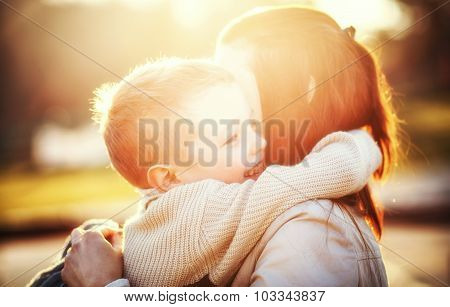 Mother Hugging Her Child In The Park