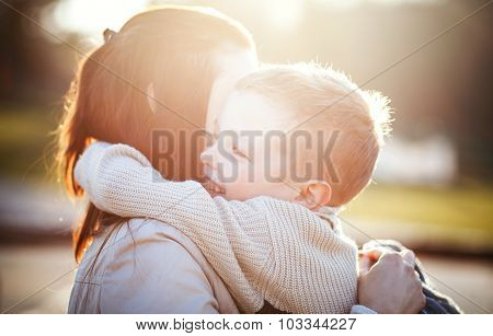 Mother Hugging Her Child In The Park