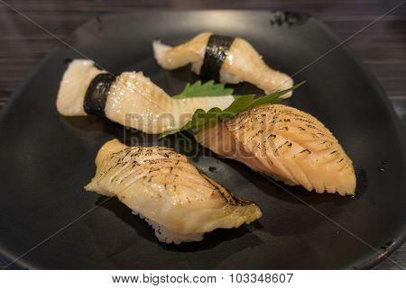 Assorted Japanese Sushi on black ceramic plate