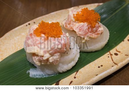 Engawa roll with salmon salad on top