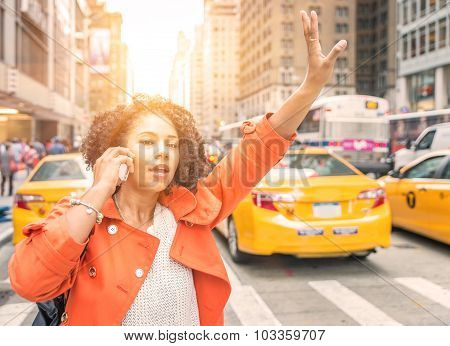Afro American Woman Calling A Taxi In New York Near Time Square District.