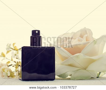 Black Perfume Bottle And White Flower