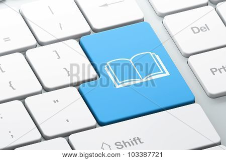 Learning concept: Book on computer keyboard background