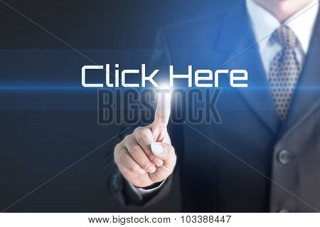 Business man pointing at CLICK HERE word for business background concept