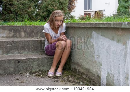Sad Child Sits On Stairs Lonely