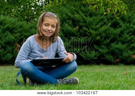 Child with tablet smiling