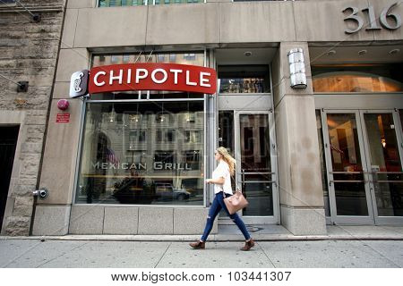 CHICAGO - FRIDAY, SEPTEMBER 25, 2015: Pedestrians walk past a Chipotle Mexican fast food restaurant.  Chipotle Mexican Grill, Inc. is a chain of restaurants.