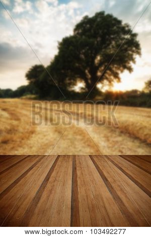Rural Landscape Image Of Summer Sunset Over Field Of Hay Bales With Wooden Planks Floor
