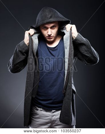Young Man In Coat With Hood