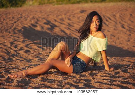 Woman sitting on the sand