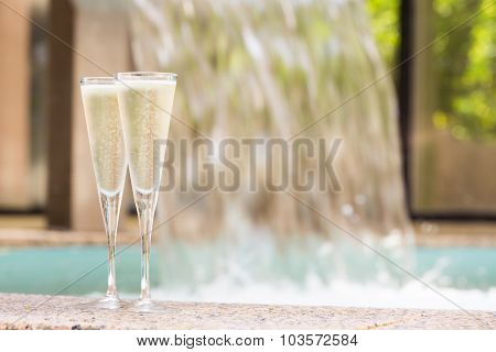 Two Glasses Of Champagne Near Outdoor Jacuzzi