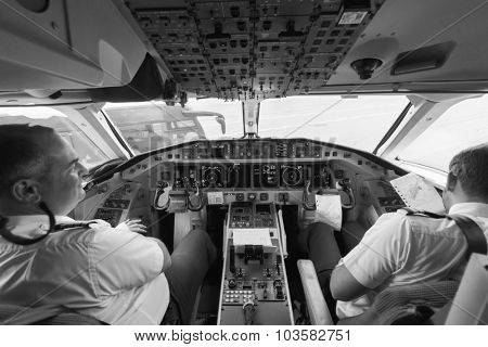 GENEVA - SEPTEMBER 11: Etihad Regional pilots in aircraft cockpit on September 11, 2014 in Geneva, Switzerland. Darwin Airline, operating under the brand name Etihad Regional since January 2014