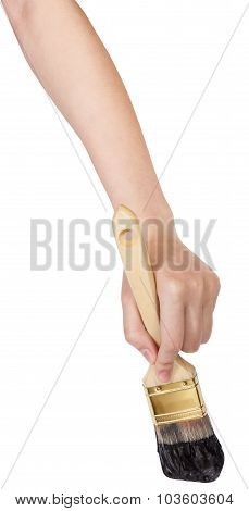 Hand With Flat Paintbrush Paints In Black Paint