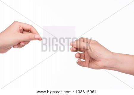 Hand passing a card. Man and woman hands passing each other a business card