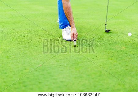 Golf Player Repairing Divot