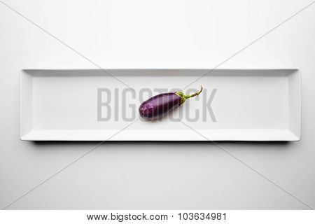Mini Eggplant Isolated On Blank White Plate