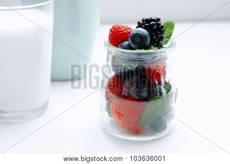 Close Up Berries And Mint In Jar And Glass Of Milk