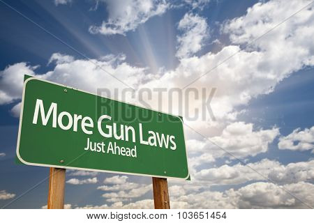More Gun Laws Green Road Sign With Dramatic Clouds and Sky.