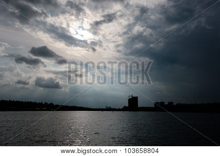 Dark cloudy evening view of Lakeshore area with few new skyscrapers constructions on the shoreside