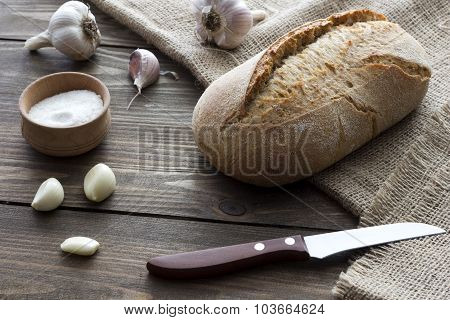 Garlic , Salt, Bread And A Knife