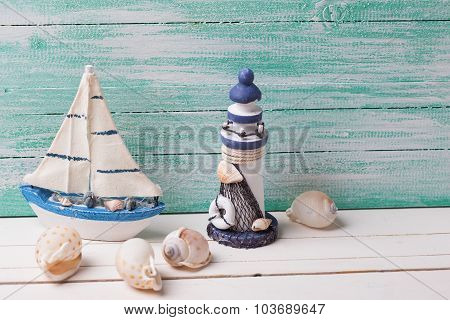 Decorative Lighthouse,  Sailing Boat And Marine Items On Wooden Background.