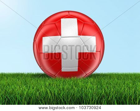 Soccer football with Swiss flag on grass