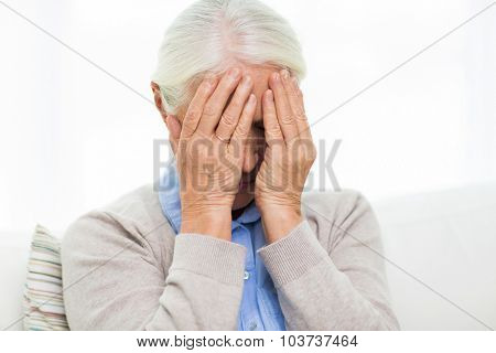 health care, pain, stress, age and people concept - senior woman suffering from headache or grief