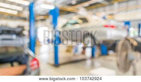 Blur Image Of Worker Fixing Car In Ther Garage.