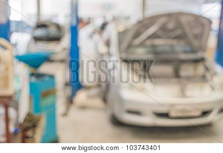 Blur Image Of Worker Fixing Car In Ther Garage.
