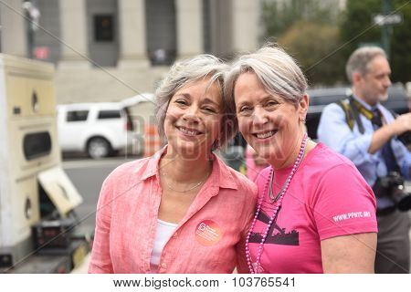 Activists in pink shirts