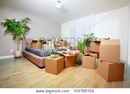 Moving boxes in new house. Real estate concept.