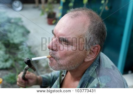 Man Lights A Cigarette