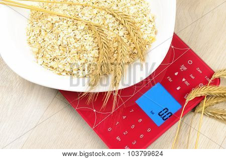 Dish Of Oatmeal On Electronic Kitchen Scales