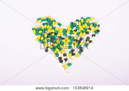 Pills, dietary supplements, drugs forming a heart