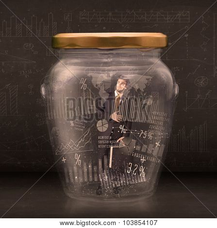 Businessman traped in jar with graph chart symbols concept on background