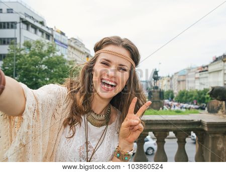 Hippy Woman Tourist Making Selfie In Prague And Showing Victory