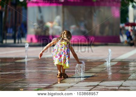 Cute Little Girl Playing With Fountain Splash