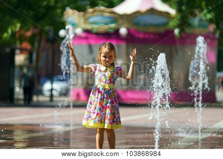 Cute Little Girl Playing With Fountain Splash