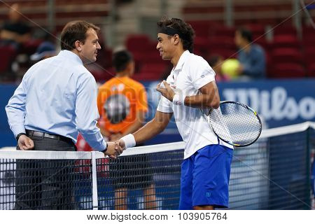 KUALA LUMPUR, MALAYSIA - SEPTEMBER 26, 2015: Syed Mohd Agil of Malaysia greets the umpire in his qualifying match in the Malaysian Open 2015 Tennis tournament held at the Putra Stadium, Malaysia.