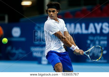 KUALA LUMPUR, MALAYSIA - SEPTEMBER 26, 2015: Syed Mohd Agil of Malaysia plays in his qualifying match in the Malaysian Open 2015 Tennis tournament held at the Putra Stadium, Malaysia.