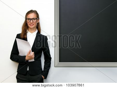 The Girl With Papers Costs At A Blackboard