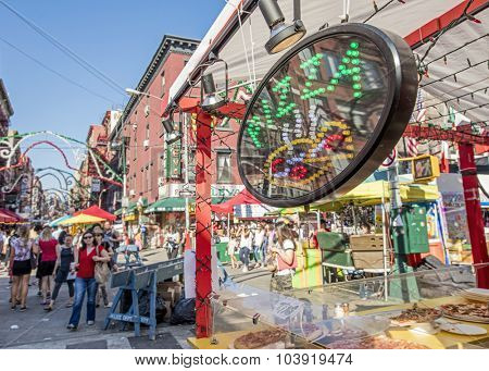 NEW YORK, USA - Sept 18th, 2015: Food vendor selling Italian food in Little Italy on Mulberry St. during the Feast Of San Gennaro. Focus is on the Pizza sign.