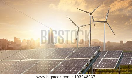 solar panels and wind turbines against city on background under blue sky. Header for website