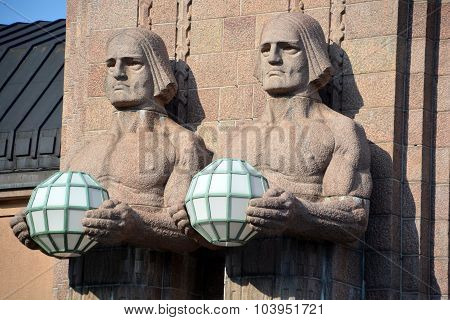 Statues holding the spherical lamps