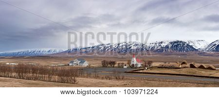 Buildings and church village near Iceland mountain landscape