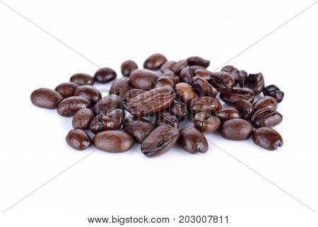 pile of roasted coffee beans arabica strong blend on white background