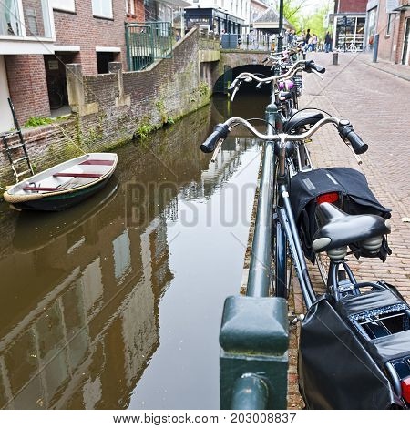 Urban scene in Amersfoort with typical local architecture and many bicycles. Street View with bikes parked on an embankment in the historical center of Amersfoort in the Netherlands