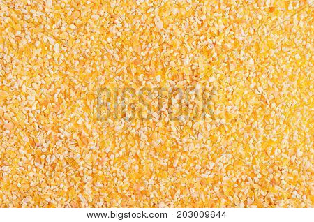 Corn grits groat background. Top view closeup.