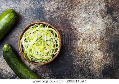 Zucchini spaghetti or noodles (zoodles) bowl. Top view copy space