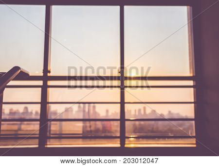 Blurred backgroundlooking up at window in sunset time to city view at stairsvintage filter